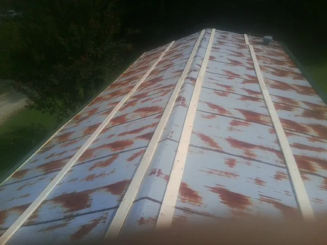 Rusted metal roof panels with new wood purlins before replacement — Storm Damage Roof Repair in Satartia by Roofing Brothers