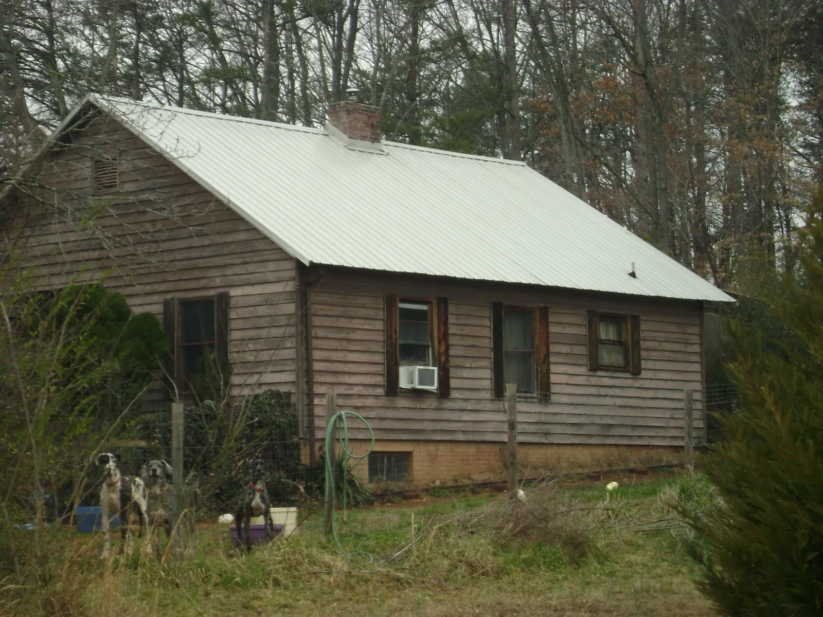White metal roof on an old wood sided farmhouse, from a Metal Roof Installation job in Satartia